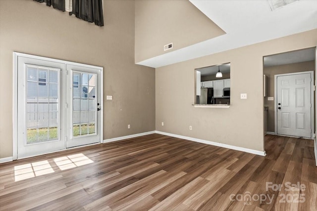 8610 Sawleaf Ct, Charlotte, NC 28215 - unfurnished living room with baseboards and wood finished floors