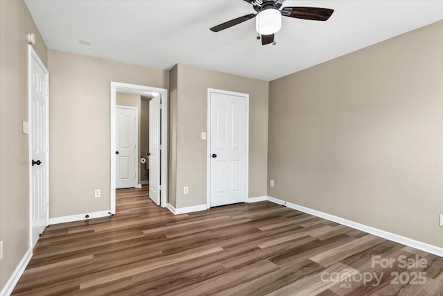 8610 Sawleaf Ct, Charlotte, NC 28215 - unfurnished bedroom featuring wood finished floors, baseboards, and a ceiling fan