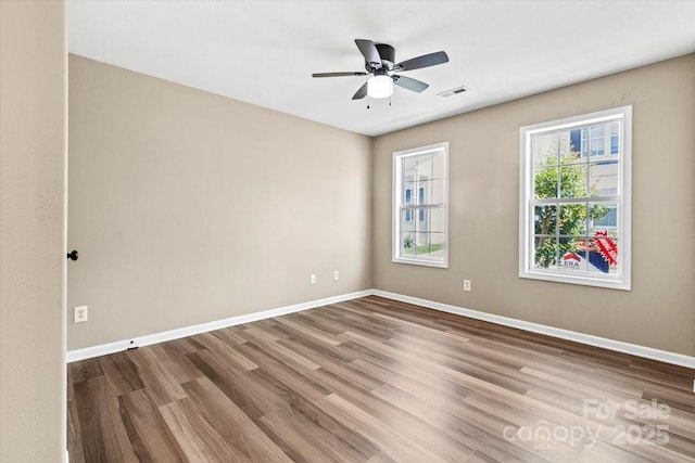 8610 Sawleaf Ct, Charlotte, NC 28215 - spare room with wood finished floors, baseboards, and ceiling fan