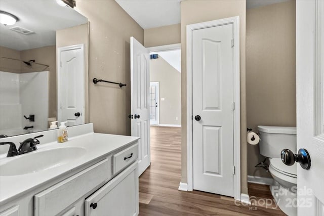 8610 Sawleaf Ct, Charlotte, NC 28215 - full bathroom with toilet, vanity, wood finished floors, a shower, and baseboards
