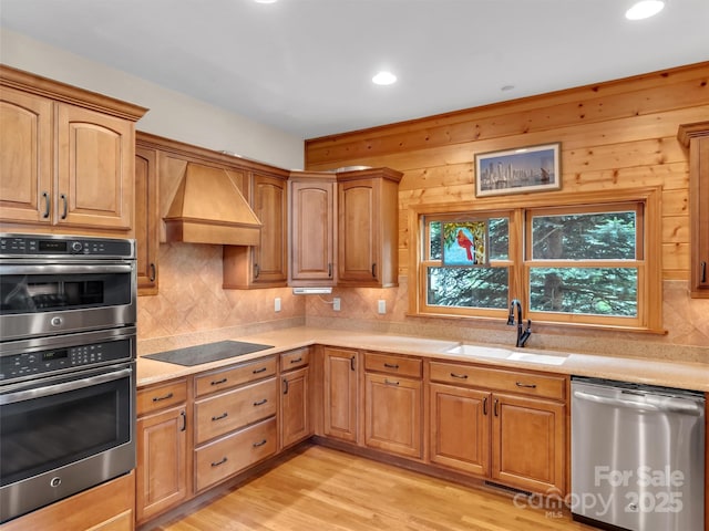 421 Ramp Patch Ln, Waynesville, NC 28786 - kitchen featuring stainless steel appliances, a sink, custom range hood, light countertops, and backsplash