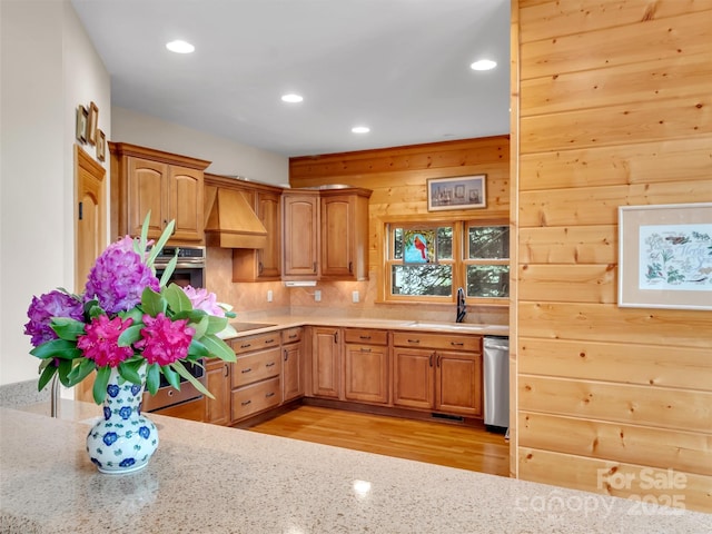 421 Ramp Patch Ln, Waynesville, NC 28786 - kitchen featuring custom range hood, appliances with stainless steel finishes, recessed lighting, light wood-type flooring, and decorative backsplash
