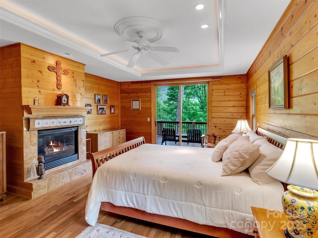 421 Ramp Patch Ln, Waynesville, NC 28786 - bedroom featuring access to outside, wooden walls, a high end fireplace, wood finished floors, and a raised ceiling