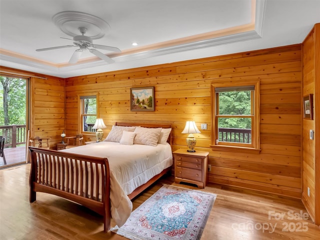 421 Ramp Patch Ln, Waynesville, NC 28786 - bedroom featuring access to outside, wood finished floors, ornamental molding, wood walls, and a ceiling fan