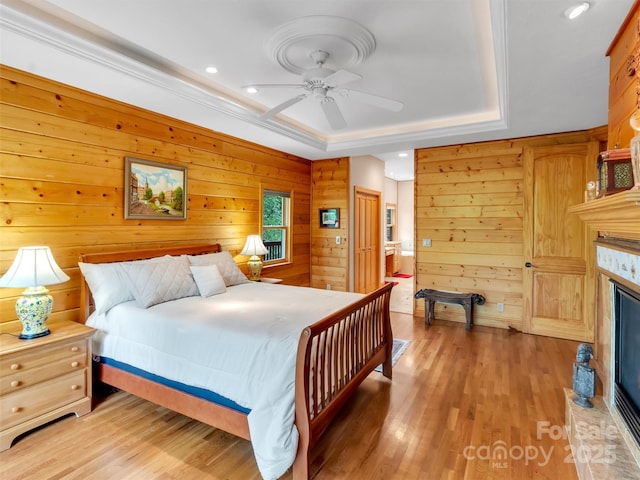 421 Ramp Patch Ln, Waynesville, NC 28786 - bedroom with a raised ceiling, light wood finished floors, wooden walls, a high end fireplace, and recessed lighting