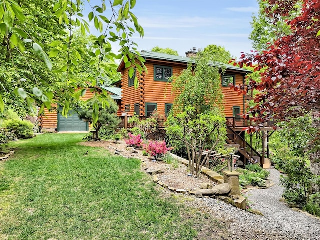 421 Ramp Patch Ln, Waynesville, NC 28786 - back of property with log siding, a yard, a wooden deck, stairway, and a garage