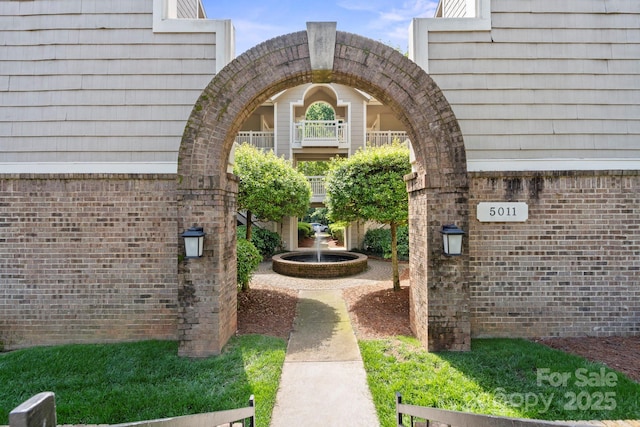 doorway to property featuring brick siding