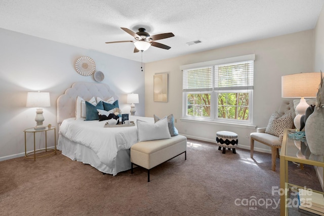 carpeted bedroom with baseboards, a ceiling fan, and a textured ceiling