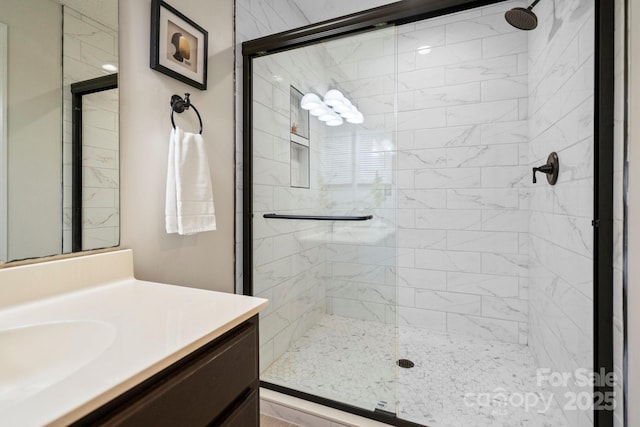 bathroom featuring a stall shower and vanity