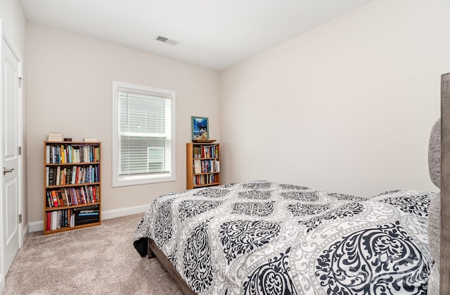 carpeted bedroom with baseboards