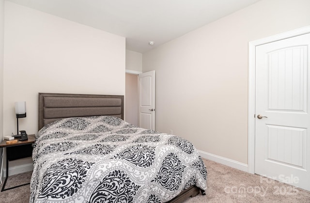 carpeted bedroom with baseboards