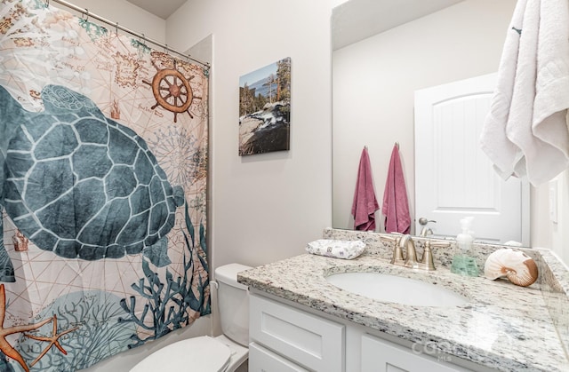 bathroom with toilet, vanity, and a shower with curtain