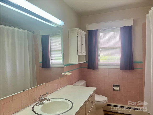 2135 Enon Rd, Morganton, NC 28655 - full bath with a baseboard radiator, tile walls, toilet, plenty of natural light, and vanity