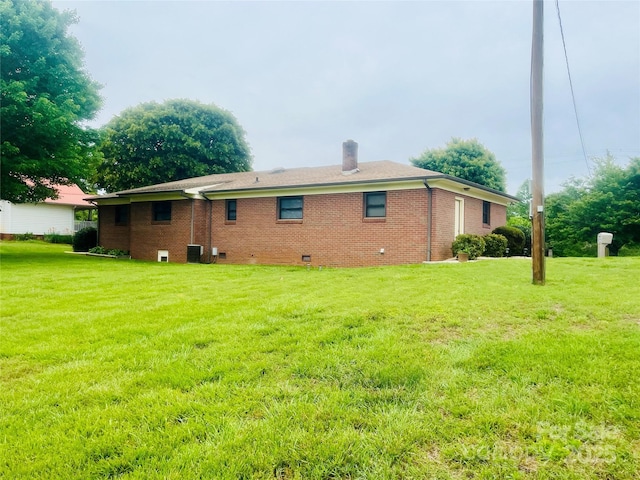 2135 Enon Rd, Morganton, NC 28655 - back of property featuring a chimney, a lawn, crawl space, and brick siding