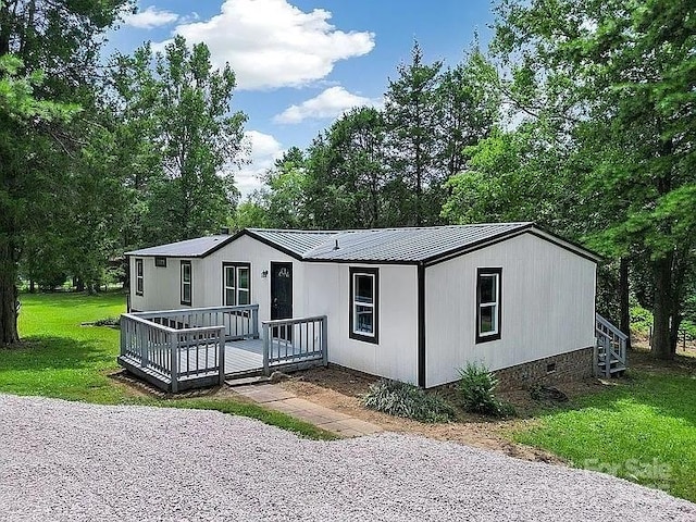 10379 Turnplow Dr, Davidson, NC 28036 - manufactured / mobile home featuring crawl space, a front yard, metal roof, and view of scattered trees