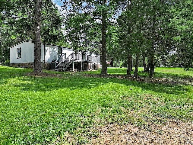 10379 Turnplow Dr, Davidson, NC 28036 - view of grassy yard with stairway, a deck, and view of scattered trees