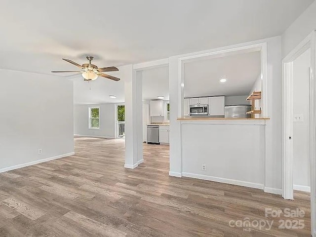 10379 Turnplow Dr, Davidson, NC 28036 - unfurnished living room featuring ceiling fan, wood finished floors, baseboards, and recessed lighting