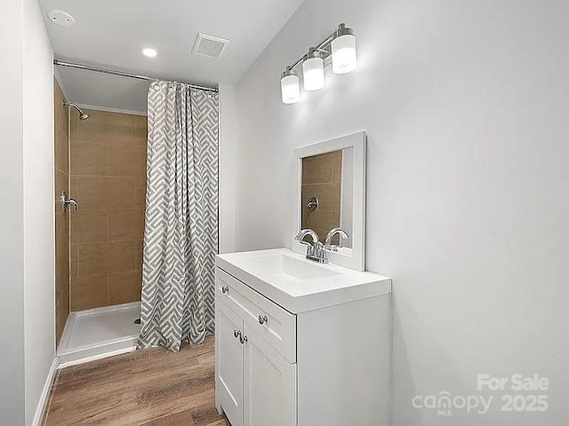 10379 Turnplow Dr, Davidson, NC 28036 - full bath featuring a shower stall, vanity, and wood finished floors