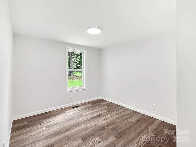 10379 Turnplow Dr, Davidson, NC 28036 - empty room featuring dark wood-style floors and baseboards