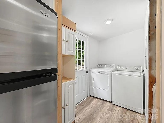 10379 Turnplow Dr, Davidson, NC 28036 - laundry area featuring separate washer and dryer and light wood-style floors