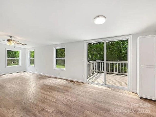 10379 Turnplow Dr, Davidson, NC 28036 - unfurnished living room with wood finished floors, a ceiling fan, and baseboards
