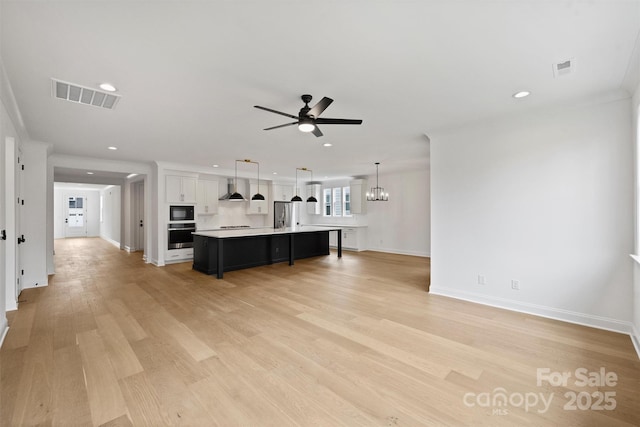 13618 Tranquil Day Dr, Matthews, NC 28105 - living area featuring ceiling fan, recessed lighting, light wood-type flooring, baseboards, and a chandelier