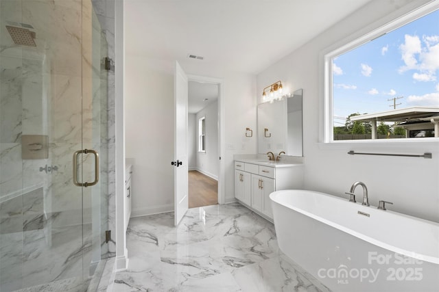 13618 Tranquil Day Dr, Matthews, NC 28105 - full bathroom with vanity, a marble finish shower, a freestanding tub, marble tiled floors, and baseboards