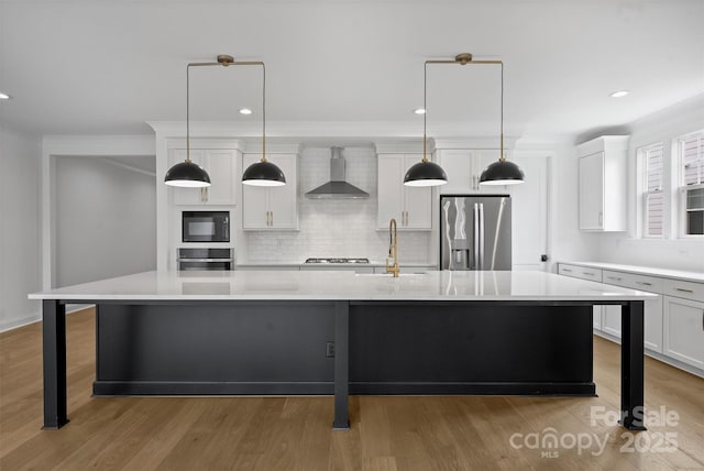 13618 Tranquil Day Dr, Matthews, NC 28105 - kitchen with stainless steel appliances, wall chimney exhaust hood, a spacious island, light countertops, and tasteful backsplash