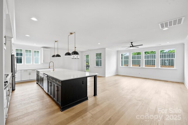 13618 Tranquil Day Dr, Matthews, NC 28105 - kitchen with recessed lighting, ceiling fan, light countertops, appliances with stainless steel finishes, and plenty of natural light