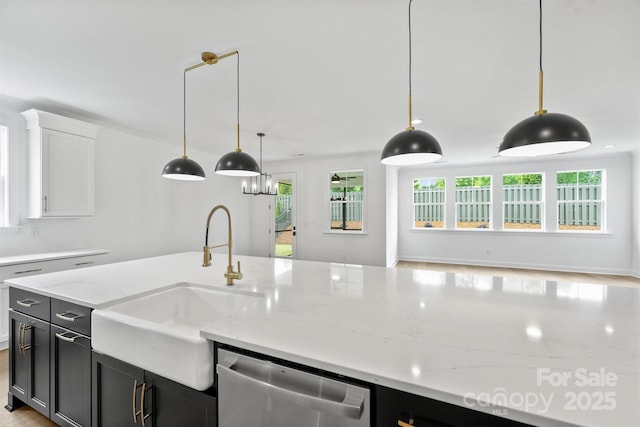 13618 Tranquil Day Dr, Matthews, NC 28105 - kitchen featuring dishwasher, a sink, dark cabinets, and hanging light fixtures