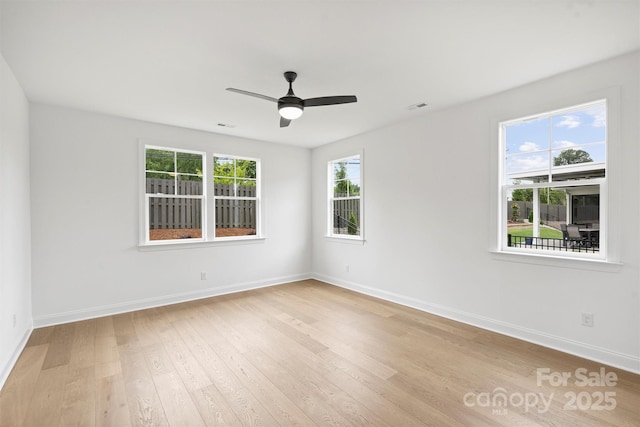 13618 Tranquil Day Dr, Matthews, NC 28105 - empty room featuring plenty of natural light, light wood-style floors, and baseboards