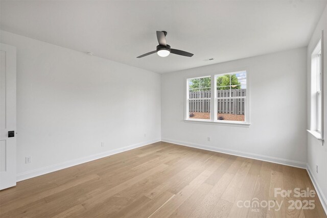 13618 Tranquil Day Dr, Matthews, NC 28105 - empty room featuring light wood-style floors, a ceiling fan, and baseboards