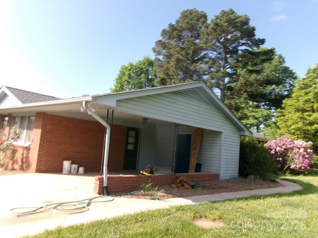 2583 Robinson Rd, Newton, NC 28658 - ranch-style home featuring concrete driveway, brick siding, an attached carport, and covered porch