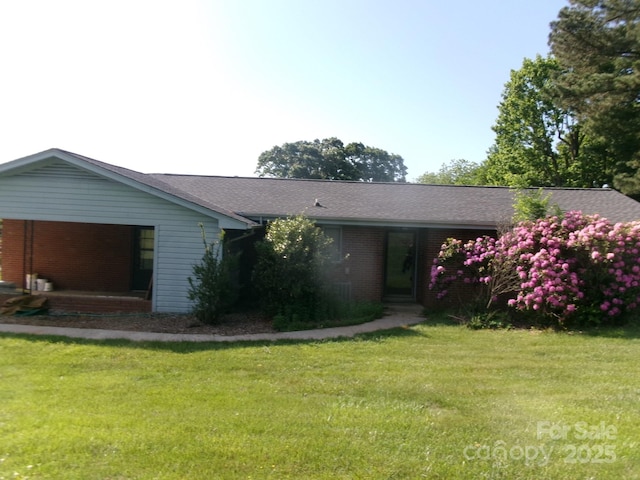 2583 Robinson Rd, Newton, NC 28658 - view of front of house featuring a front yard, brick siding, and roof with shingles