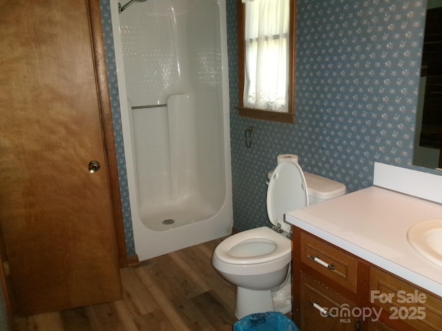 2583 Robinson Rd, Newton, NC 28658 - full bathroom featuring wood finished floors, a shower stall, vanity, wallpapered walls, and toilet