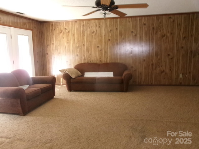 2583 Robinson Rd, Newton, NC 28658 - living room with carpet flooring, wood walls, and a ceiling fan