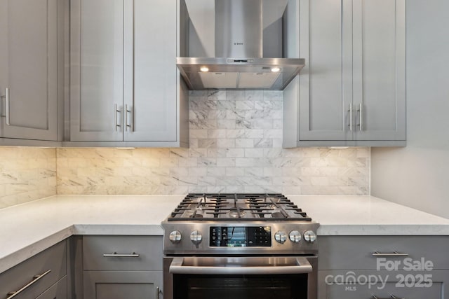 7908 Rea View Ct, Charlotte, NC 28226 - kitchen with stainless steel gas range oven, gray cabinets, island range hood, and tasteful backsplash