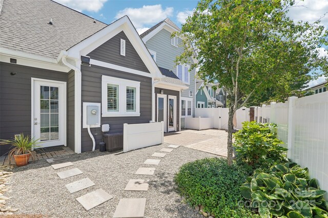 7908 Rea View Ct, Charlotte, NC 28226 - back of property with a fenced backyard, a patio area, and a shingled roof