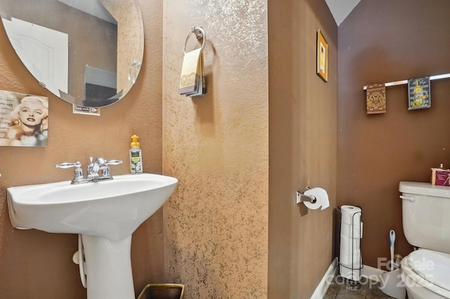 1332 Waterlily Ln, Charlotte, NC 28262 - bathroom featuring toilet and baseboards