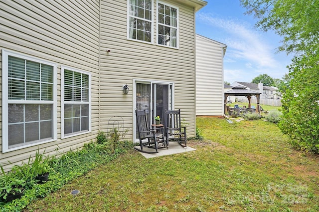 1332 Waterlily Ln, Charlotte, NC 28262 - rear view of property featuring a gazebo, a lawn, and a patio