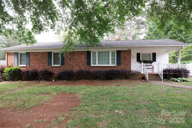 ranch-style home with a porch, a front lawn, and brick siding