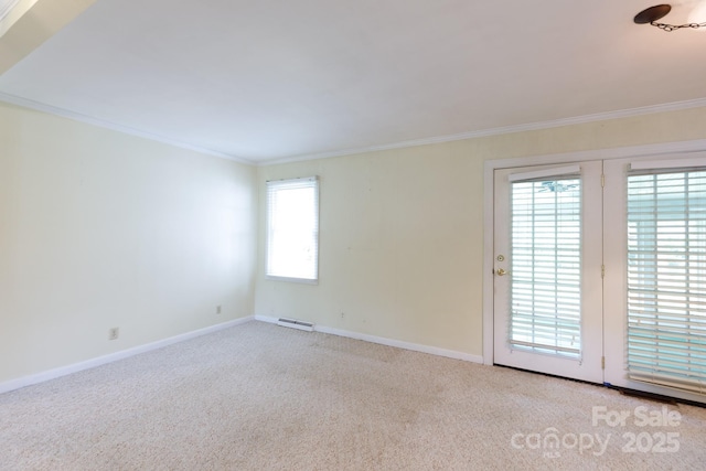 carpeted spare room with baseboards and crown molding