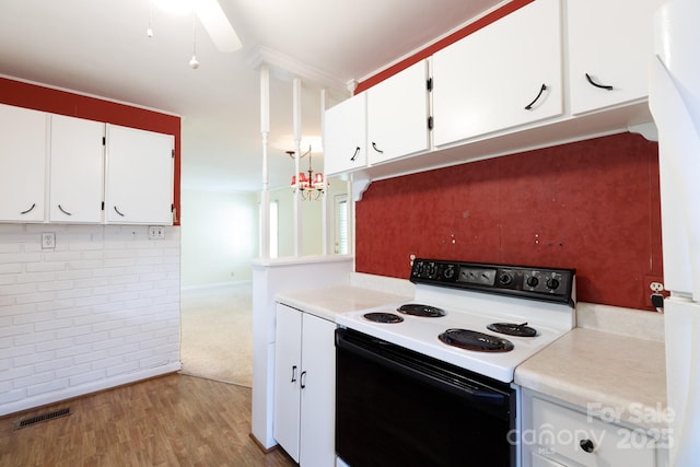 kitchen featuring range with electric cooktop, light countertops, white cabinets, and wood finished floors