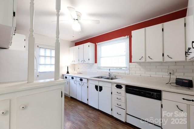 kitchen featuring dishwasher, a sink, backsplash, a ceiling fan, and dark wood-style floors