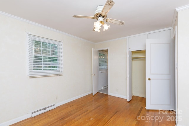 unfurnished bedroom with a baseboard radiator, crown molding, light wood-style floors, a closet, and baseboards