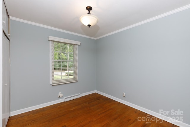 spare room featuring a baseboard radiator, dark wood-style flooring, baseboards, and crown molding
