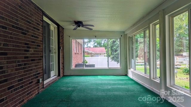 unfurnished sunroom with carpet and lofted ceiling
