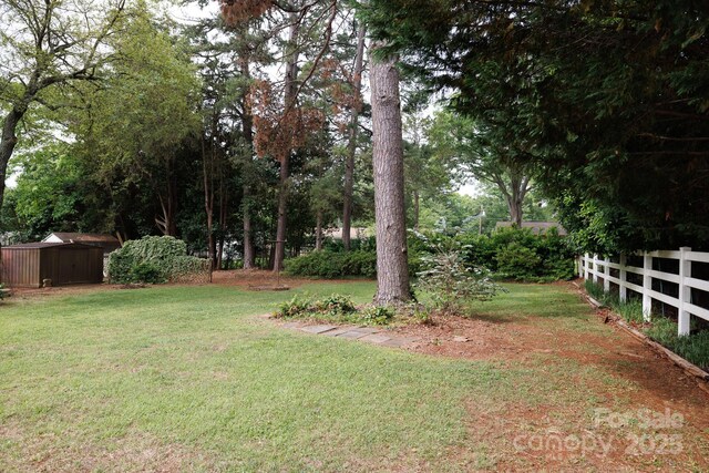 view of yard featuring an outbuilding and a shed