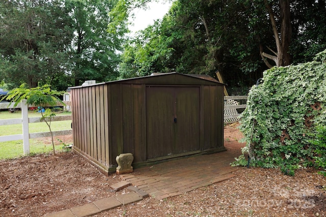 view of shed with fence