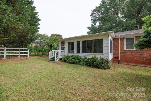 rear view of property with brick siding